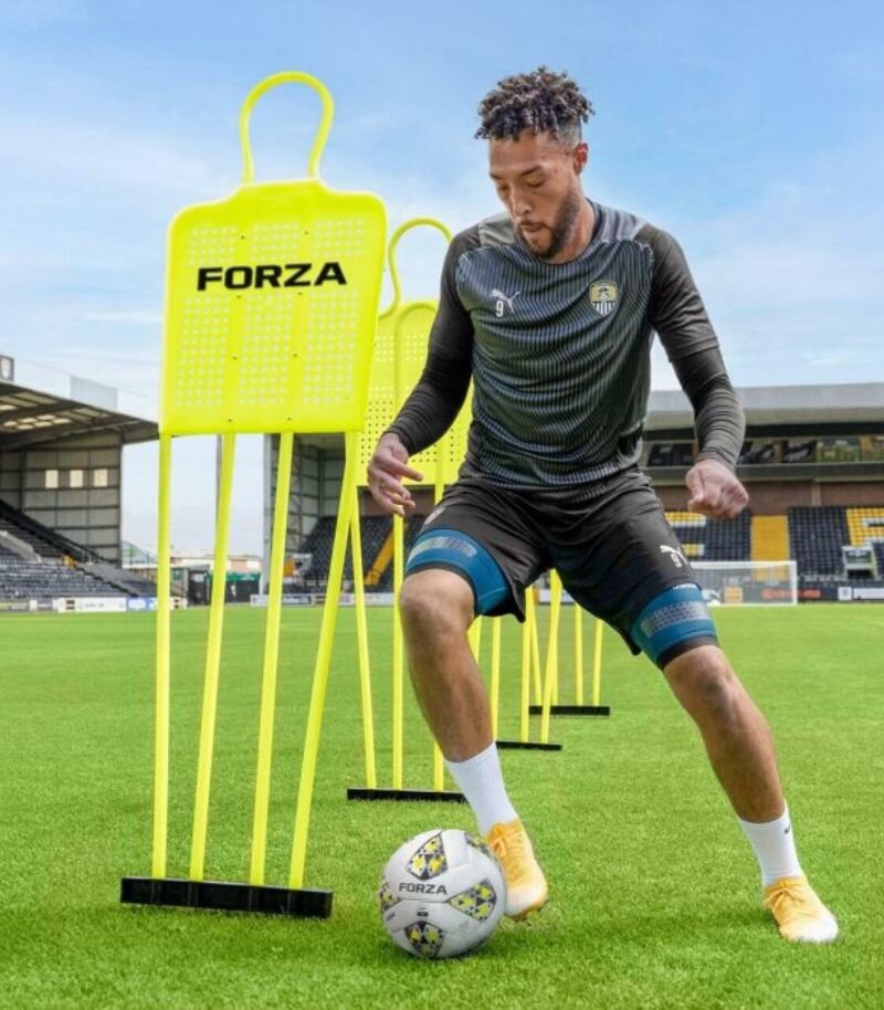 Yellow forza football mannequin with player dribbling round 